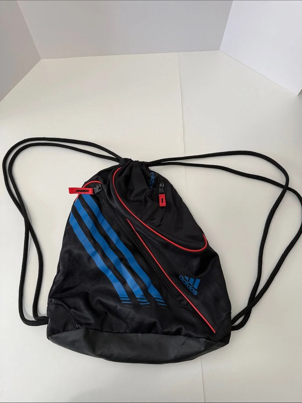 adidas Black Drawstring Backpack with Blue Stripes and Red Accents